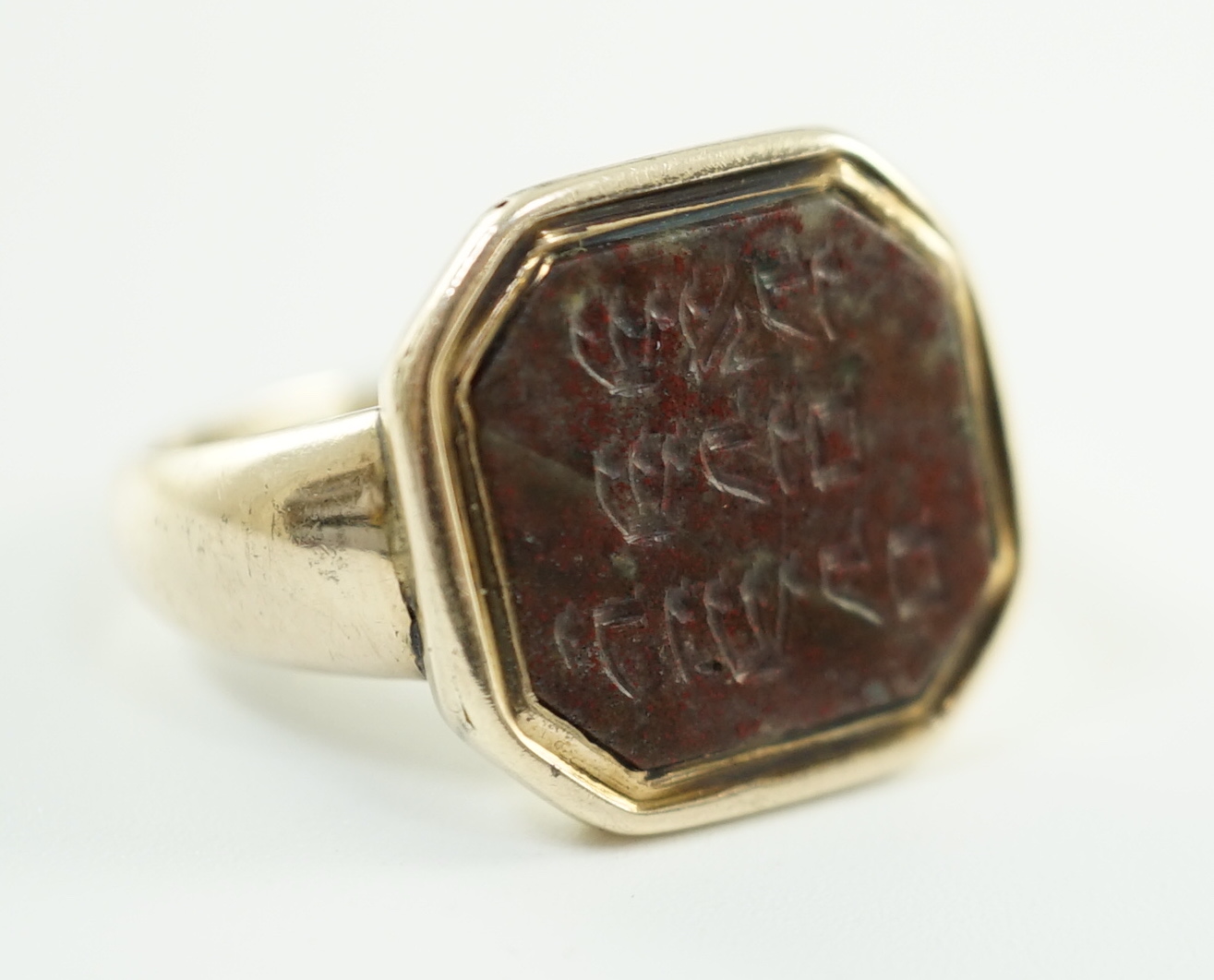 Judaica: A 19th century gold and jasper set ring, the stone carved with Hebrew script